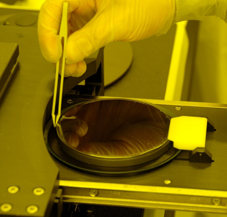 Wafer is carefully placed atop plastic circle.
