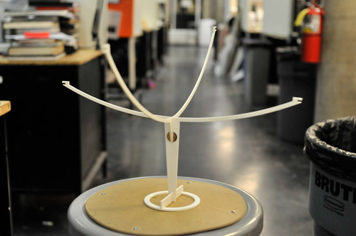 Photo of the assembled lamp stand, with four thin curved supports on the top.