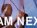 Photo of a man mending a fishing net, overlaid with the words 'I AM NEXT.'