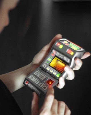 A woman gazes at her tricorder, decoding the various signs and signals of life.