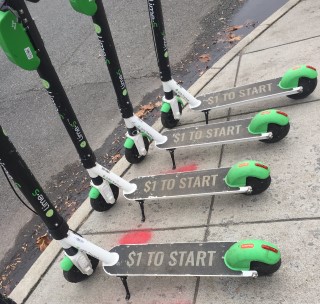 Three identical scooters with "$1 to start" printed on them
