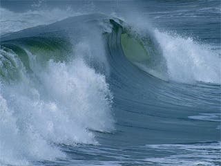 A photograph of an ocean wave cresting.