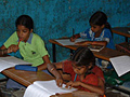 Photo of school-aged children in class.