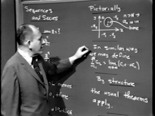 Image of Herb Gross in front of the chalkboard.