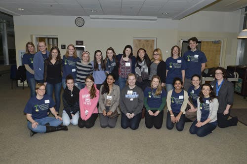 A group of adults pose together for a photograph.