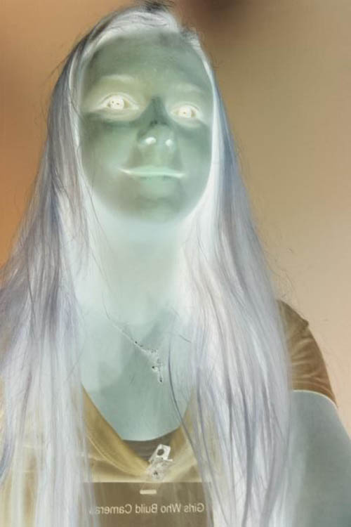 A negative-processed photo of a girl.