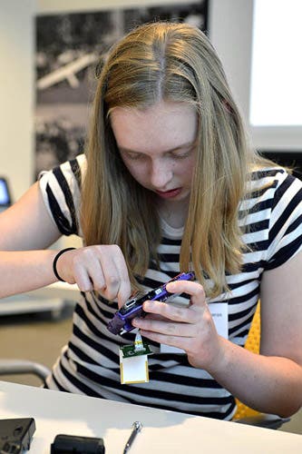 A photo of a girl working with a camera.