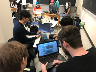 A photo of students working on computers in a classroom.