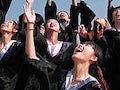 Students throwing graduation caps in the air. 