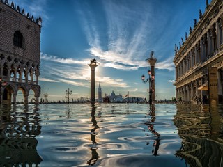 Buildings and monuments reflected in flood waters.