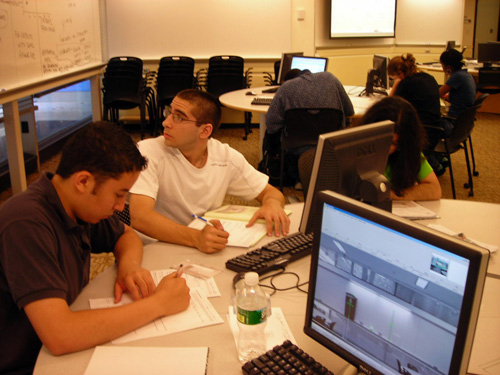 A photo of students working at round tables learning about linear size analysis. 