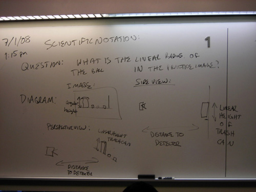 Handwritten notes on a whiteboard about scientific notation