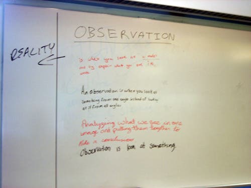 A whiteboard with notes written on it about explanations and definitions of observation.