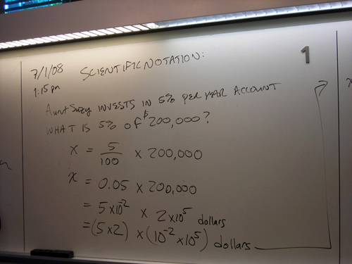 Handwritten notes on a white board about scientific notation