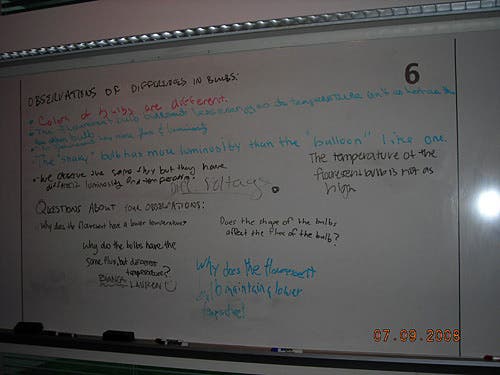 Handwritten notes on a whiteboard about observations of differences in bulbs. 