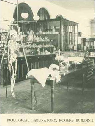 An old photograph from a biology lab at MIT in the 1800s. There is a skeleton in the foreground.