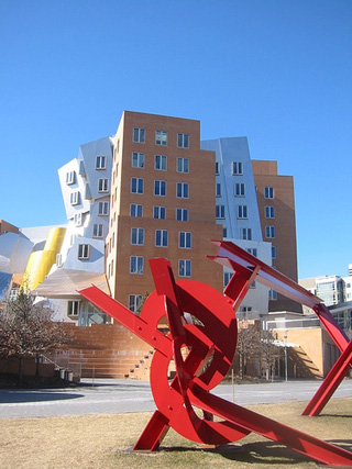 A photograph of the Stata Center at MIT, with a red sculpture in the foreground.