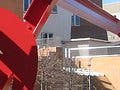 A photograph of the Stata Center at MIT, with a red sculpture in the foreground.