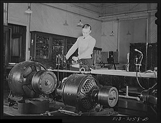 A black and white photograph of Jim Tillma in the electrical engineering laboratory. University of Nebraska, Lincoln.