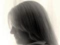 A sideview of a woman with an extended stomach.