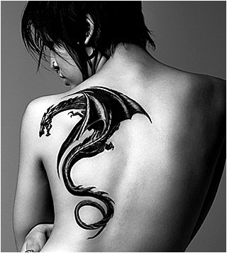 A black and white photograph of a large dragon tattoo on a woman's back.